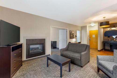 a living room with a couch and a chair and a television at Best Western Plus Grant Creek Inn in Missoula