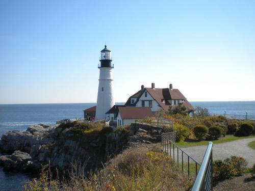 a lighthouse on a cliff next to the ocean at Benjamin F. Packard House Bed and Breakfast in Bath