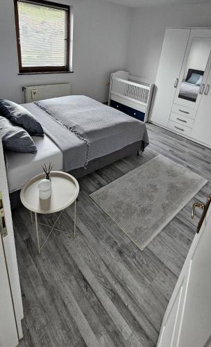 a bedroom with a bed and a coffee table at Apartman STARI GRAD in Bihać
