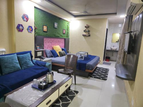 a living room with a couch and a tv at Hotel Mari Aai Residency in Navi Mumbai