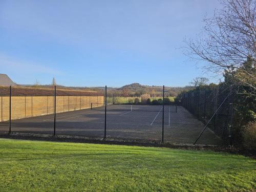 a tennis court with two tennis courts at The Byre - Luxury Barn, near Wells, Somerset, pool, gym in Wells