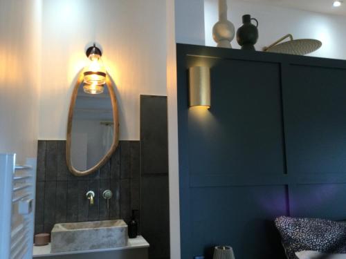 a bathroom with a sink and a mirror at Chambre Cosy Chic in Challans
