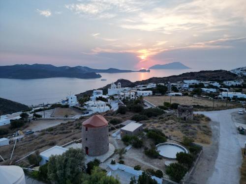 a sunset over a small town with a tower at Marketos Traditional Windmill in Tripití