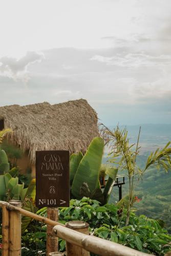 a sign in front of a building with a view of the ocean at Casa Malva Villas in Buenavista