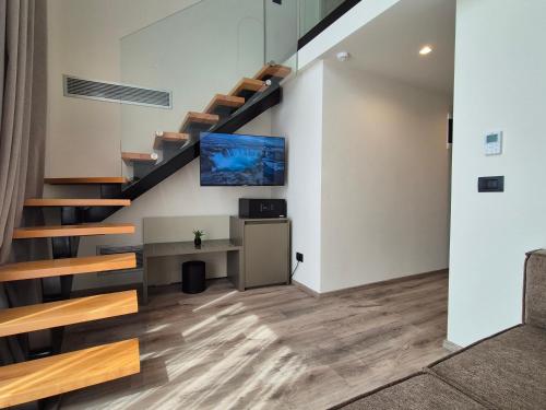 a staircase in a house with a living room at Meraviglia Boutique Hotel in Sarandë