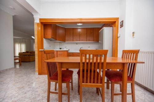 a kitchen with a wooden table and chairs at Siagito Apartment in Stavros
