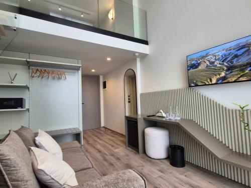 a living room with a couch and a staircase at Meraviglia Boutique Hotel in Sarandë