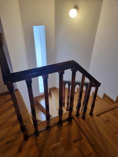 a wooden stair rail in a room with a window at Kraljevi Konaci Olja in Zlatibor
