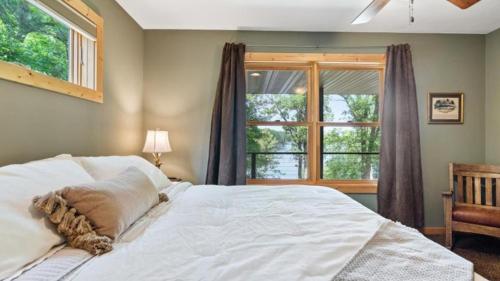 a bedroom with a white bed and a window at 5 Pines on Ossie by Woods to Water in Breezy Point
