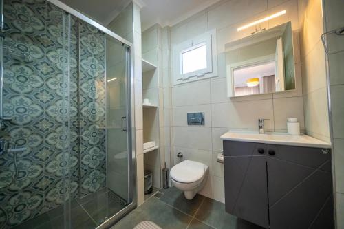 a bathroom with a shower and a toilet and a sink at Villa Necati Bey in Marmaris