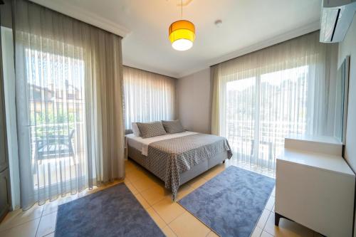 a bedroom with a bed and a large window at Villa Necati Bey in Marmaris