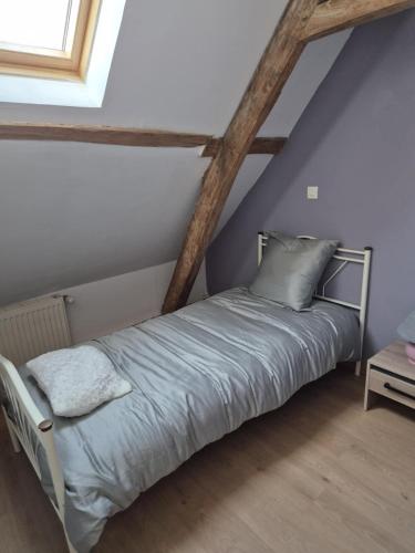 a bedroom with a bed in a attic at Maison à la campagne in Tollent
