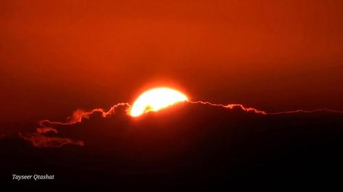 an image of the sun setting behind clouds at Dana's scenic trails in Dana