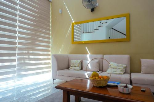 a living room with a couch and a table at Spacious Eco Guest House Colombo in Sri Jayewardenepura Kotte