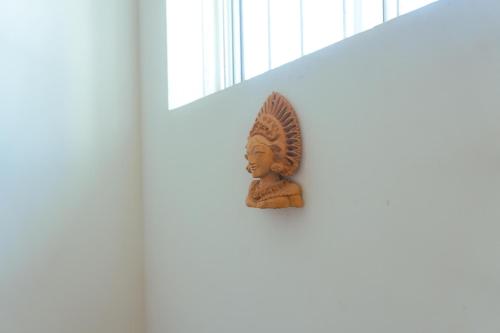 a buddha statue on the side of a wall at Spacious Eco Guest House Colombo in Sri Jayewardenepura Kotte