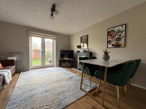a living room with a table and a couch at Beautifully renovated 2bed home in North Stifford