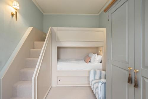 a childs room with a bunk bed under the stairs at The Townhouse, Leith in Edinburgh