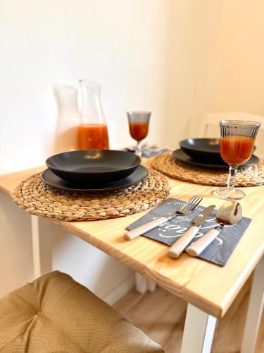 a table with two black plates and glasses on it at Wohnung in Siegen in Wilnsdorf