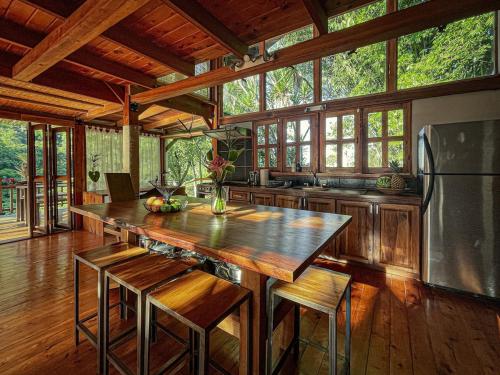 a kitchen with a large island in a house at Kubla Khan - Chirripó Mountain Riverfront Retreat in Rivas