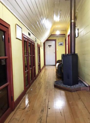 an empty hallway of a building with a wood floor at La casa Florencia in Puerto Varas