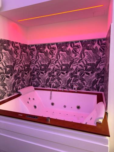 a white bath tub in a room with a wall at Sweet 23 in Brindisi