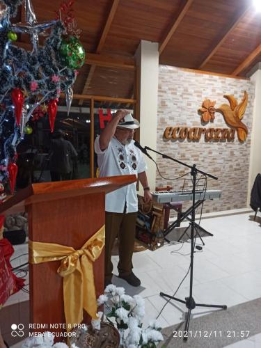 a man standing at a podium with a microphone at Eco Arazzá in Mera