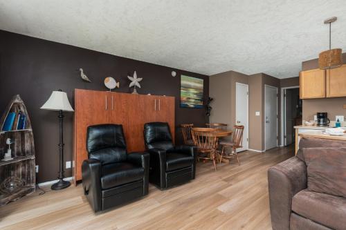 a living room with two chairs and a table at Ocean Terrace Condominiums in Lincoln City