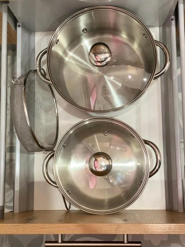 three metal pans sitting on top of a shelf at Cabo Beach Home 1 in Cabo Negro