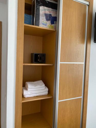 a book shelf with a microwave and a towel at Cabo Beach Home 1 in Cabo Negro