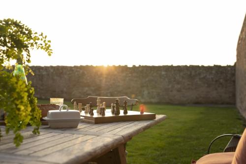 a chess game on a wooden table in a garden at New Ladykirk Farmhouse in Ladykirk