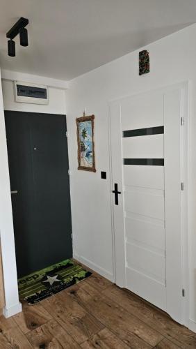 a room with a closet with a cross on the wall at Robert's New studio apartment Łódź Widzew in Łódź
