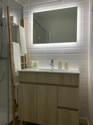 a bathroom with a sink and a mirror at Casa da Fonte in Mangualde