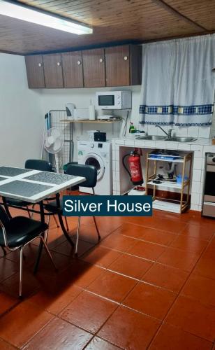 a kitchen with a dining table and a silver house at Golden House in Angra do Heroísmo