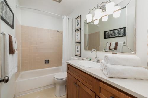 a bathroom with a sink and a tub and a toilet at Ocean Terrace Condominiums in Lincoln City