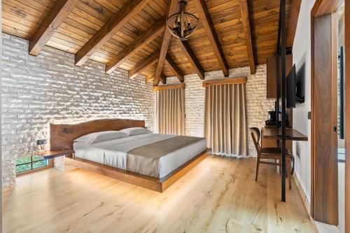 a bedroom with a bed in a brick wall at GrandView Hotel in Berat