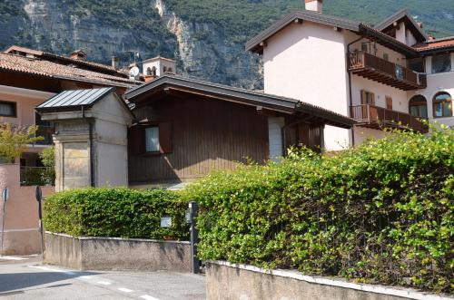 a house with a mountain in the background at Residenza Al Capitello in Ceniga