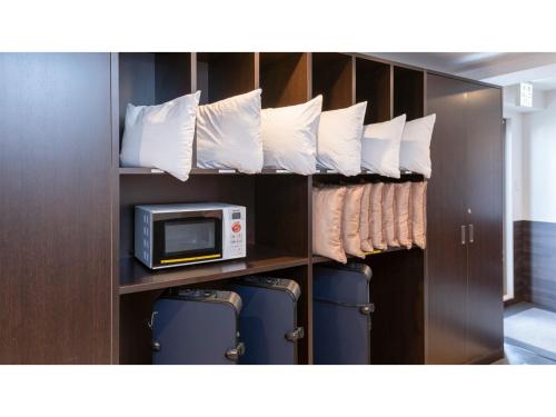 a room with a microwave and some towels at Hotel Koza - Vacation STAY 84943v in Okinawa City
