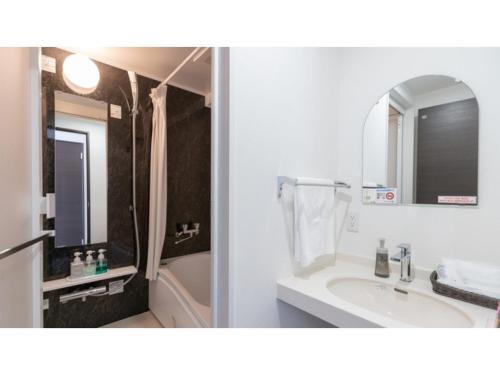 a bathroom with a sink and a shower and a mirror at Hotel Koza - Vacation STAY 84943v in Okinawa City