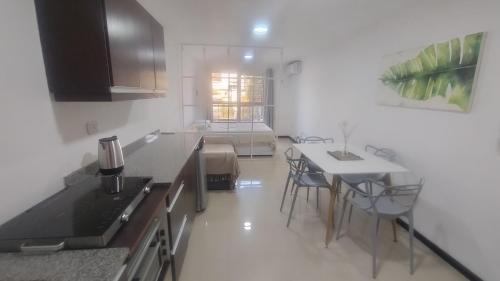 a kitchen with a table and chairs in a room at Franco l in Posadas