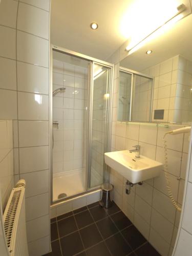a bathroom with a sink and a shower at Aparthotel Amelie in Vienna