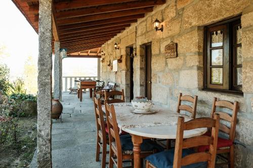 a table and chairs on a patio at Casa dos Castros in Travassós
