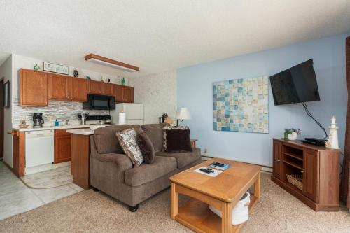 a living room with a couch and a table at Ocean Terrace Condominiums in Lincoln City