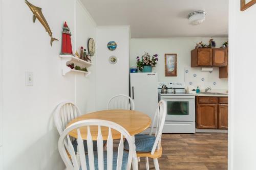 a kitchen with a wooden table and chairs at Ocean Terrace Condominiums in Lincoln City
