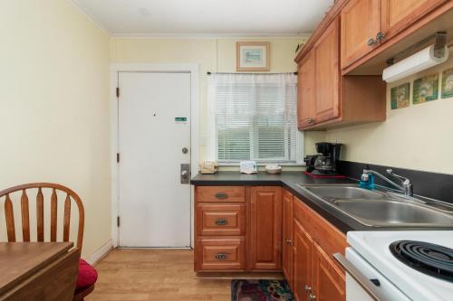 a kitchen with wooden cabinets and a sink at Ocean Terrace Condominiums in Lincoln City