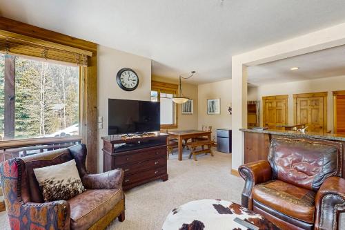 a living room with a couch and a tv at Settler's Creek 6524 in Keystone