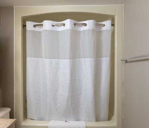 a white shower curtain in a bathroom at Motel 6-Branford, CT - New Haven in Branford