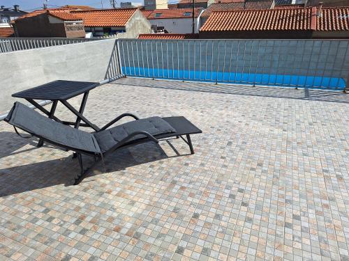a picnic table and a bench next to a pool at Aver Beach Haven in Póvoa de Varzim