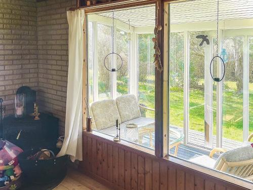 a room with a large window with chairs in it at 6 person holiday home in Dannemare in Dannemare