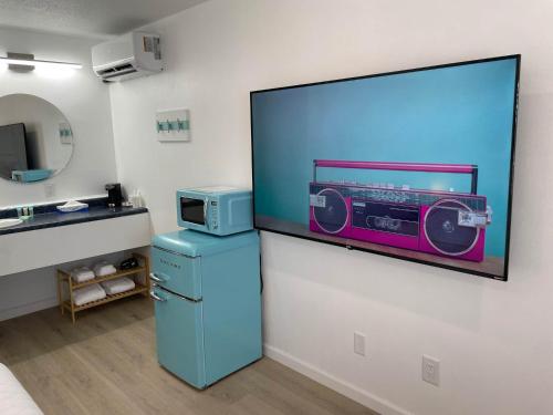a room with a blue refrigerator and a microwave at Poolside Double Rooms in Lake City