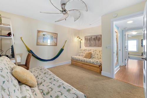 a bedroom with a bed and a hammock at Scenic 2br Beachfront Condo Retreat Nsb Fl in New Smyrna Beach